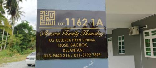 a sign on the side of a building at Ameera family homestay in Bachok