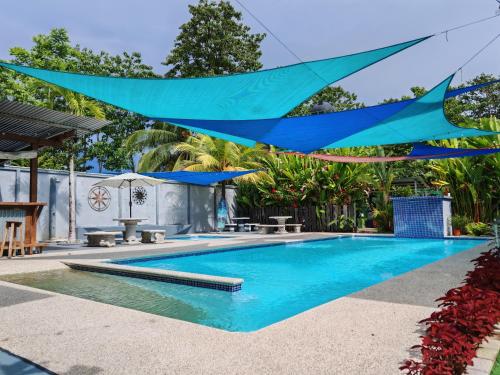 a blue sarong is hanging over a swimming pool at La Cuna Inn in Puerto Jiménez