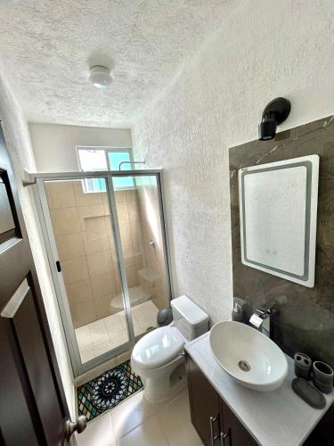 a bathroom with a toilet and a sink and a shower at Sumergete Nueva Residencia en Playa del Carmen in Playa del Carmen