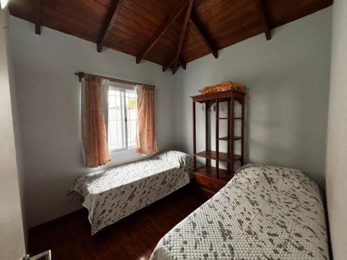 a bedroom with two beds and a window at Family Home en Costa Azul in Costa Azul