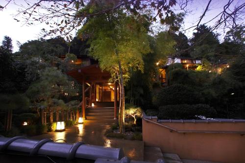 a house with a pathway leading up to it at night at 山の茶屋 in Hakone