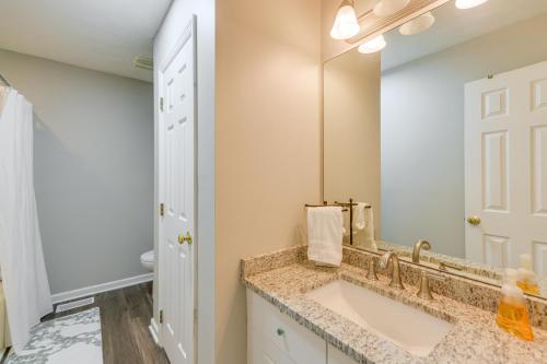 a bathroom with a sink and a mirror at 2 Mi to Tiger Territory! Condo with Community Pool in Auburn