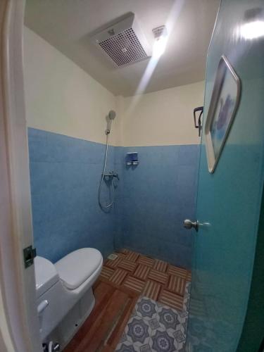 a bathroom with a shower with a toilet and a shower at Stella Dell Mare Homestay and Tours in Labuan Bajo