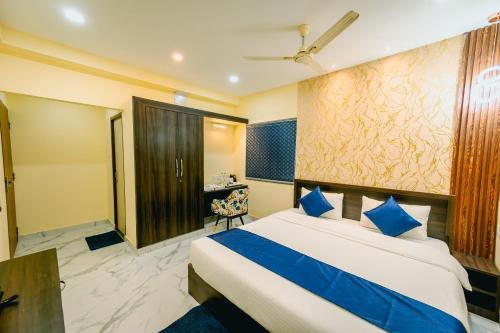 a hotel room with a bed and a desk at Livotel Premium Hotel in Bhubaneshwar