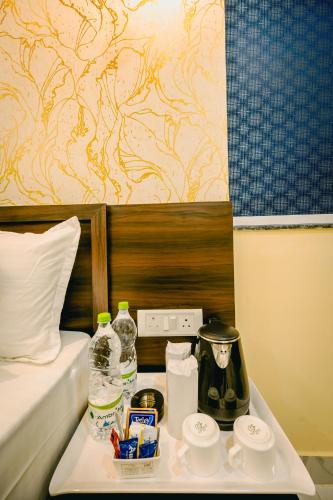 a hotel room with a tray of food on a bed at Livotel Premium Hotel in Bhubaneshwar