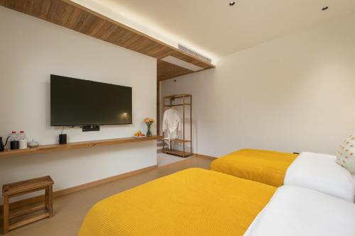 Ένα ή περισσότερα κρεβάτια σε δωμάτιο στο Flower Hotel Jiuhuashan Blossoms Not Yet Full