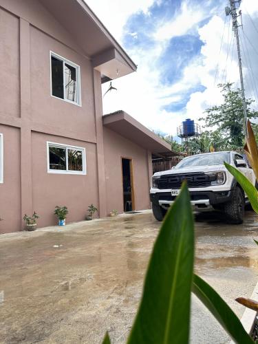 a truck parked in front of a house at Captain CLIFFs House in Pilar