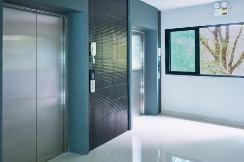 a bathroom with a shower with a glass door at Family room in Baan Pakdi Pattaya in Pattaya Central