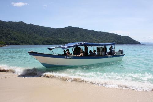 a group of people in a boat on the beach at Hotel Santiago Plaza Acandí in Acanti