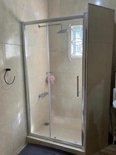 a shower with a glass door in a bathroom at A Caribbean Oasis 