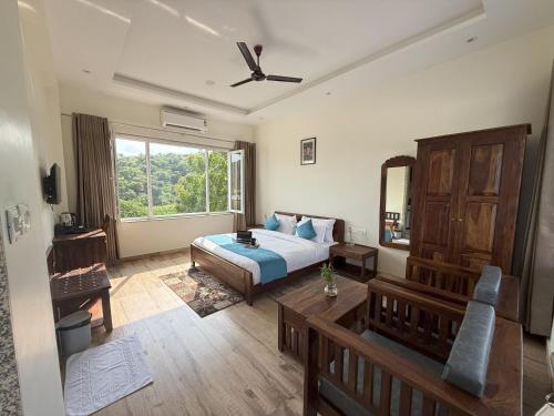 a bedroom with a bed and a large window at 3BR Abode with Plunge Pool and Monsoon place view in Udaipur