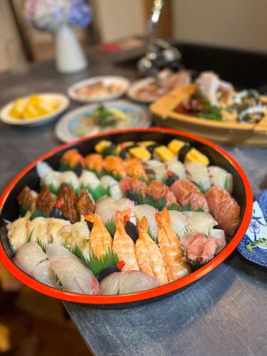 a tray of sushi and other foods on a table at 港ノ宿 マルコ in Kami Amakusa