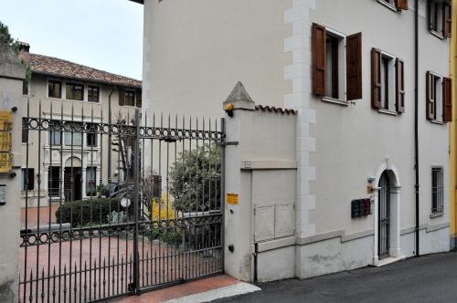 Una puerta a un edificio blanco con una valla. en Palazzina Gelsomino, en Desenzano del Garda