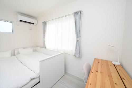Postel nebo postele na pokoji v ubytování 結-Yui-Takasaki