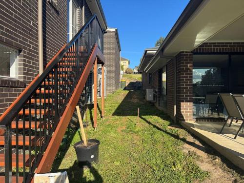 a porch of a house with a fence and a yard at KINGI Granny Flat in Batemans Bay