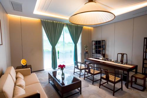 a living room with a couch and a table at Huafeng Hotel 