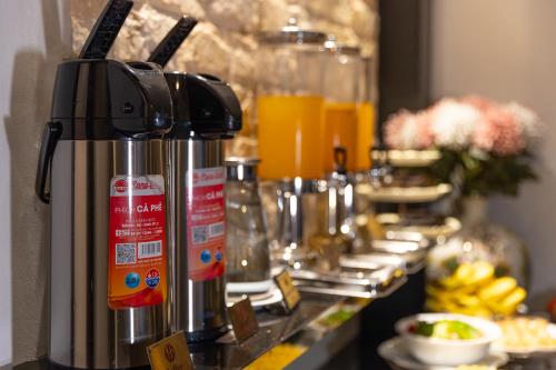 a row of coffee machines sitting on a counter at Hanoi House Hotel & Travel in Hanoi