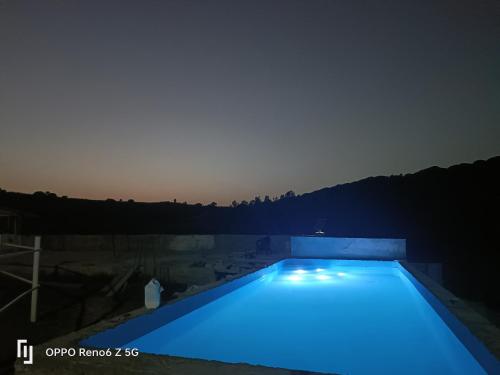 a swimming pool with blue lights in the dark at Lodge Alhambra in Tangier