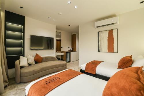 a hotel room with two beds and a couch at Royal Regency Hotel in Cairo