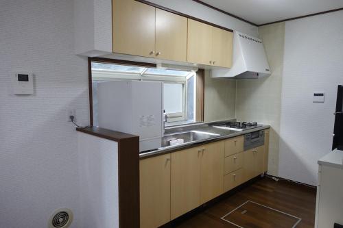 a small kitchen with a sink and a window at 4BR Entire House near Nikko & Highway EV Parking in Nikko