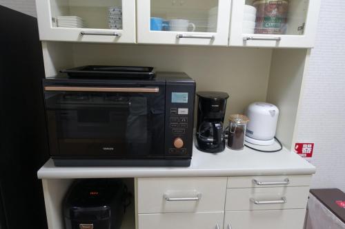 a microwave sitting on top of a kitchen counter at 4BR Entire House near Nikko & Highway EV Parking in Nikko