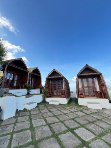 two cottages with windows on a patio at Bali Sunrise Camp & Glamping in Kintamani