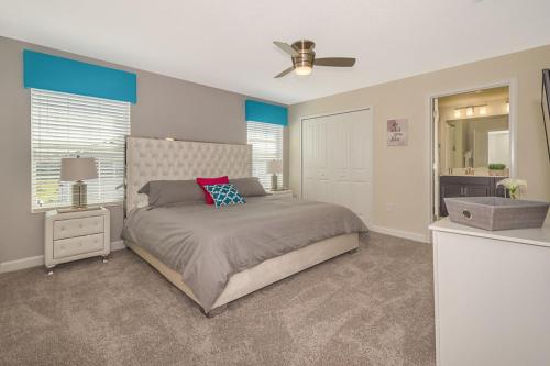 a bedroom with a bed and a ceiling fan at Stunning Townhouses 5 Minutes away Disney! in Kissimmee