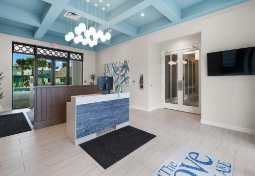 a living room with blue ceilings and a tv at Stunning Townhouses 5 Minutes away Disney! in Kissimmee