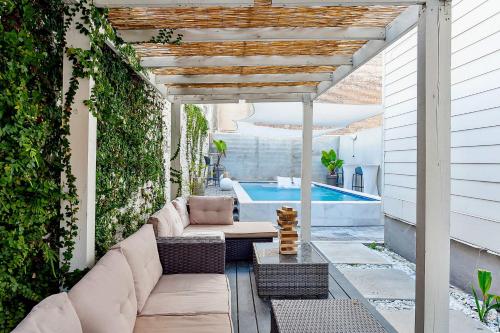 a patio with a couch and a swimming pool at 5 bedroom Villa w private rooftop in New Orleans