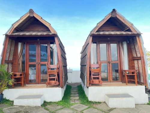 two chinese style homes with chairs in them at Bali Sunrise Camp & Glamping in Kintamani
