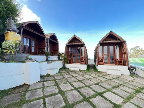 a set of three cottages with windows at Bali Sunrise Camp & Glamping in Kintamani