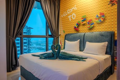 a bedroom with a bed with two towels on it at Macrolink Medini Theme Suite by Nest Home - Near Legoland in Iskandar Puteri