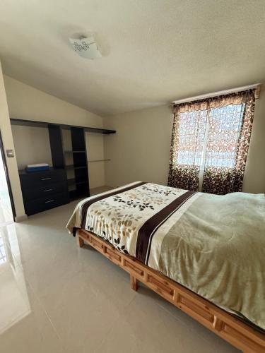 a bedroom with a bed and a window at Casa de dos pisos,Ciudad Tolteca in Tula de Allende