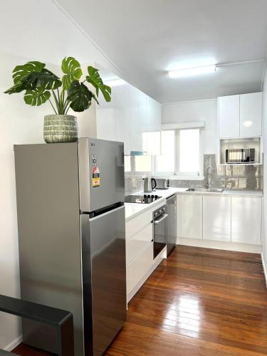a kitchen with a stainless steel refrigerator and a potted plant at 2bedrm unit next to southbank in Brisbane