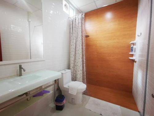 a bathroom with a toilet and a sink and a mirror at บุญเมืองน่าน in Nan