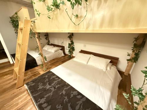a bedroom with two bunk beds with plants at Eternity APARTMENT HOTEL SHINAGAWA in Tokyo
