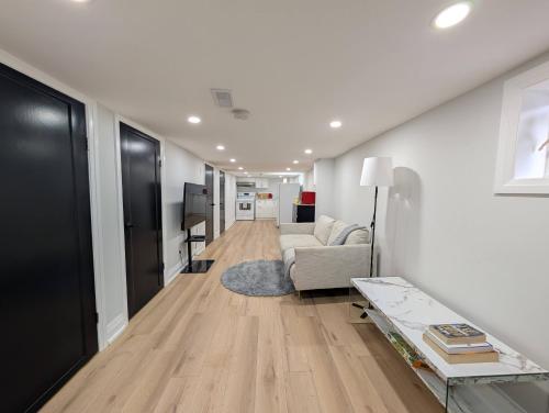 a living room with a couch and a table at The Urban Hideaway - Stylish Stay - Prime Spot in Hamilton