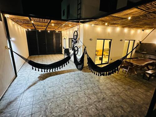 a large room with a hammock in the middle of it at Sumergete y Relajate, Nueva Residencia en Mérida in Mérida