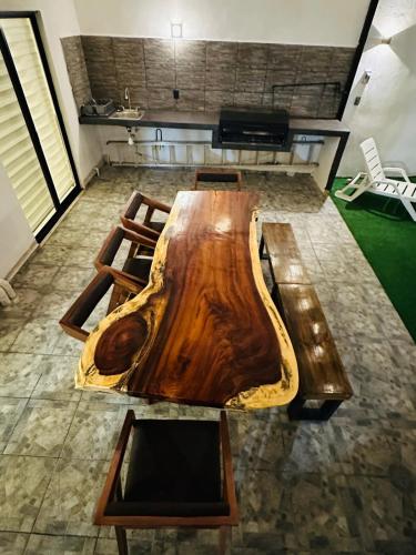 a large wooden table in the middle of a room at Sumergete y Relajate, Nueva Residencia en Mérida in Mérida