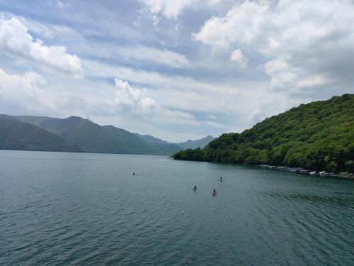 a group of people swimming in a large lake at 4BR Entire House near Nikko & Highway EV Parking in Nikko