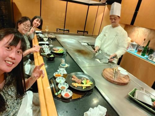 a group of people in a kitchen preparing food at 4BR Entire House near Nikko & Highway EV Parking in Nikko