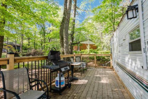 a patio with chairs and a grill on a fence at 2-bedroom Camper Trailer Cottage #1 in Dillon