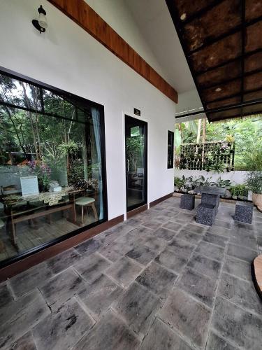 a room with a large window and a patio at Le-Mao Chiang Dao in Chiang Dao