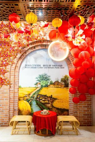a wall with an arch with a painting on it at Doha Central Bliss Danang Hotel by Haviland in Da Nang