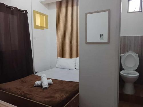 a small room with a bed and a toilet at NON AIRCON STUDIO TYPE UNIT Salvacion Palo Room 9 in Palo