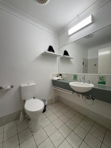 a bathroom with a toilet and a sink at Parkview Apartments in Brisbane