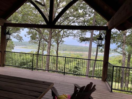 a screened in porch with a bench and a view at The Lofty Cabin at Pettit Bay 