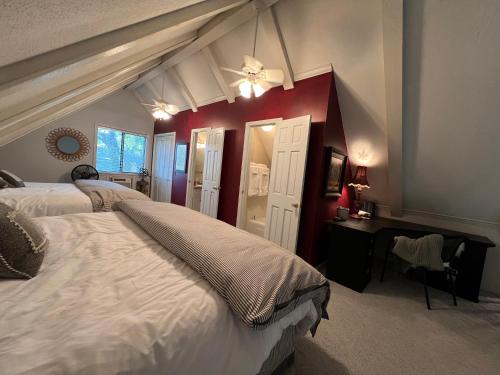 a bedroom with two beds and a desk with a window at The Lofty Cabin at Pettit Bay 