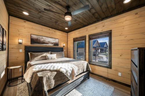 a bedroom with a bed in a room with wooden walls at Modern Rooftop Mtn Views, Hot Tub, Indoor Pool, Near Dollywood & PS5 in Pigeon Forge