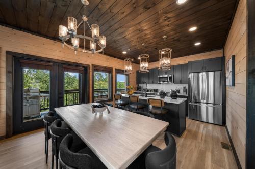a kitchen and dining room with a table and chairs at Modern Rooftop Mtn Views, Hot Tub, Indoor Pool, Near Dollywood & PS5 in Pigeon Forge